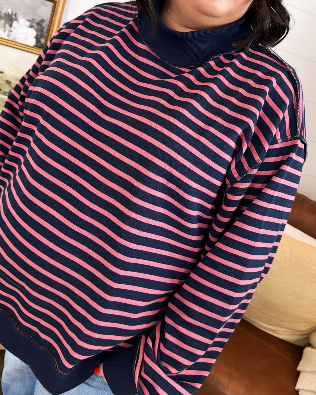Close-up of the navy striped pullover showing the mock neck