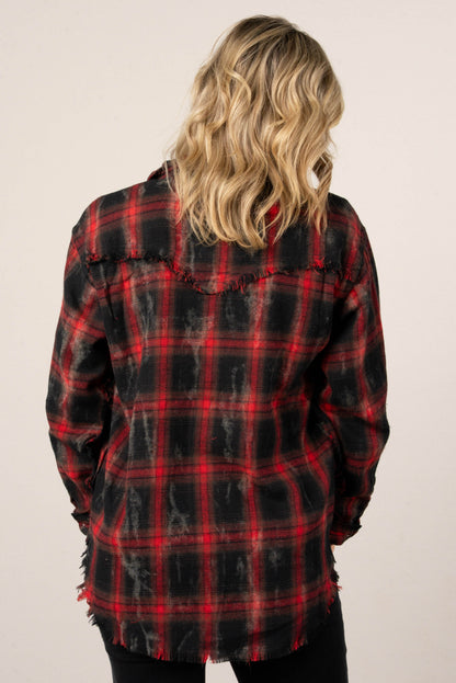 A back view of a woman with blonde hair, wearing a red and black distressed plaid button-down shirt. The back of the shirt features a yoke with a frayed edge.