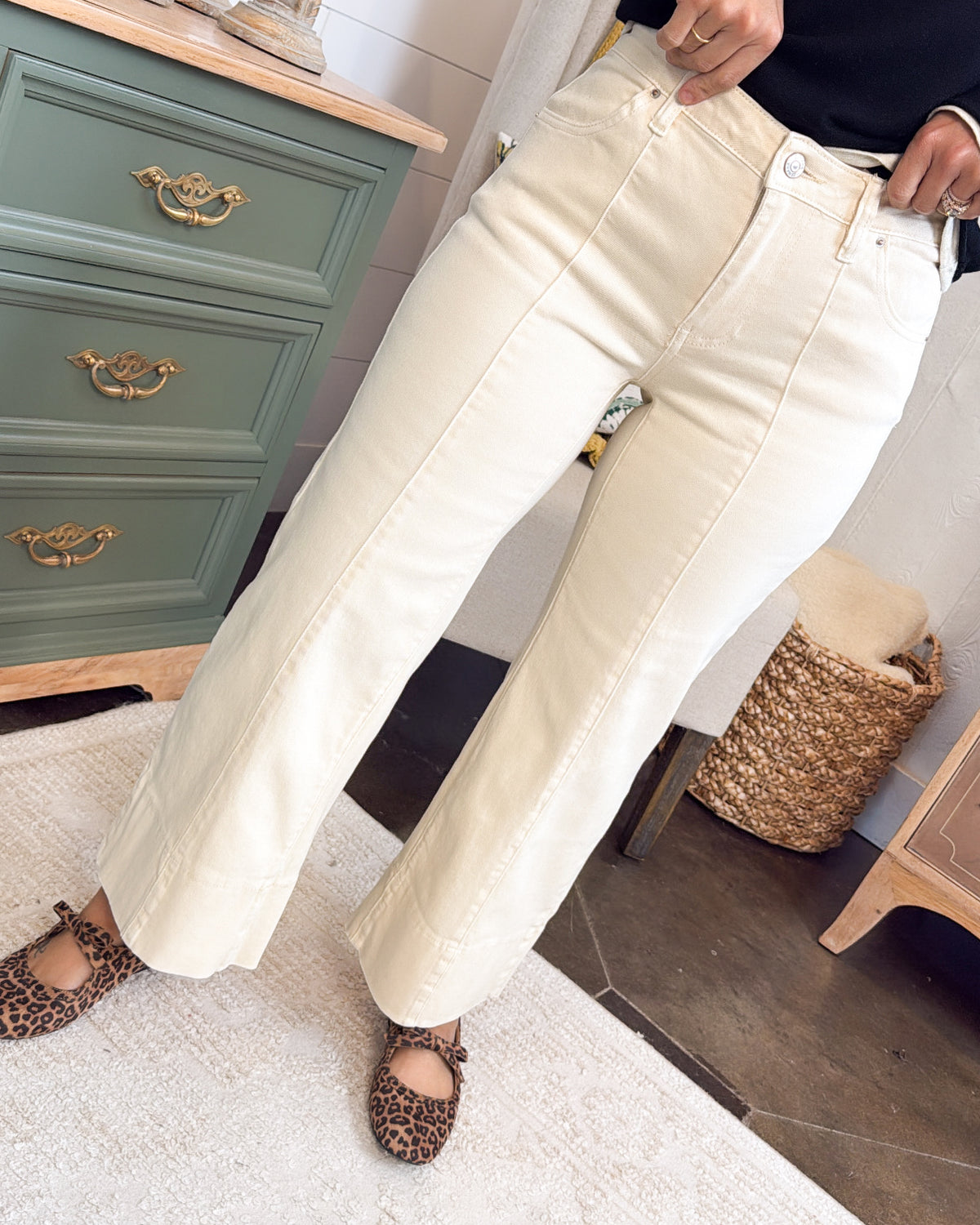 Close-up of cream mid rise crop wide leg jeans with brown sandals
