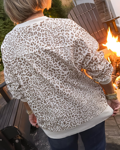 Back view of an oversized cream leopard print corded pullover with a ribbed hem