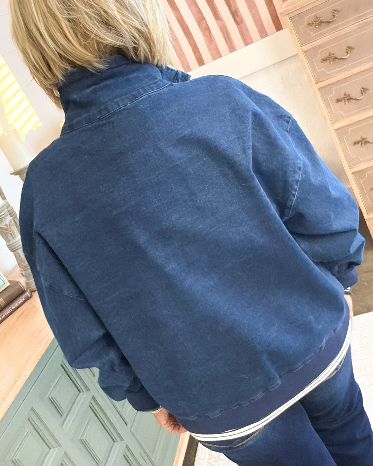 Back view of the navy washed pullover with a relaxed fit and dropped shoulders