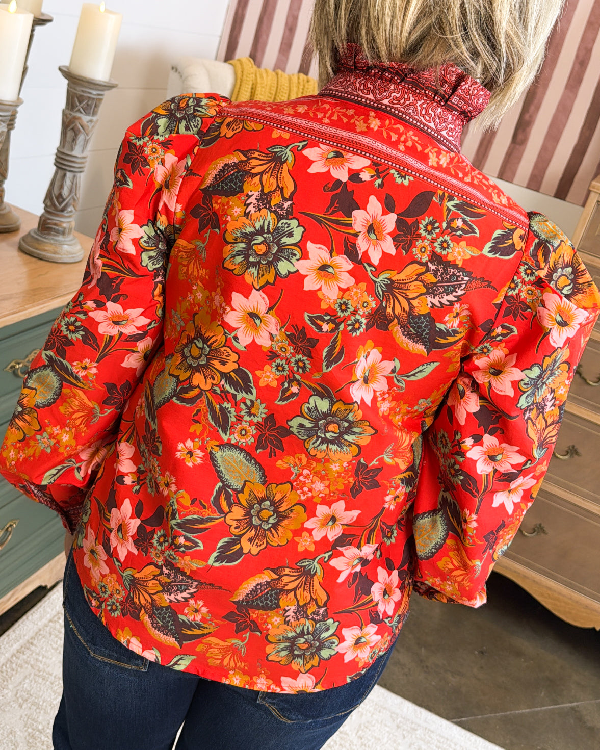 Back view of the red floral blouse showing the ruffle collar and border print trim