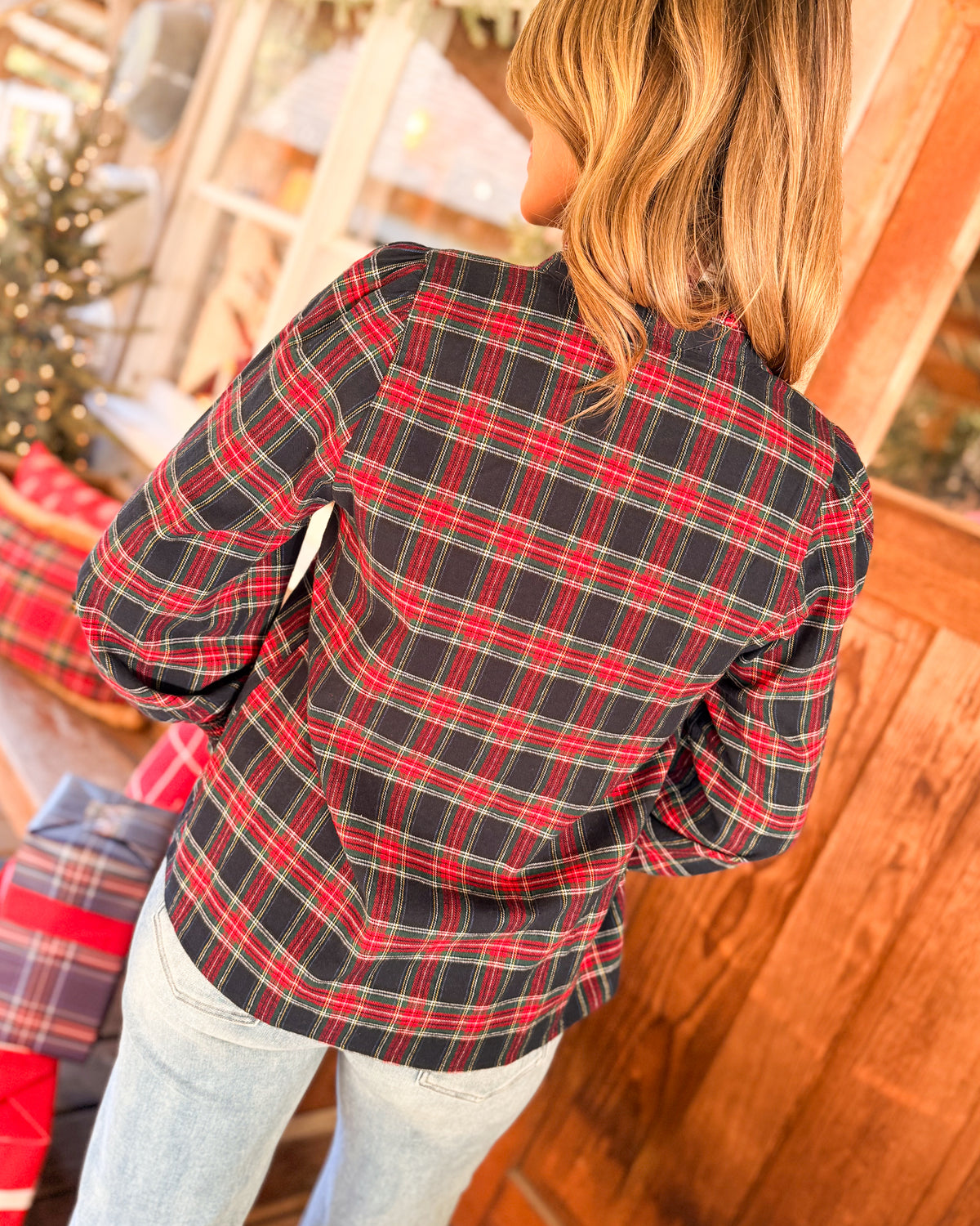 Back view of a navy and red plaid long sleeve shirt