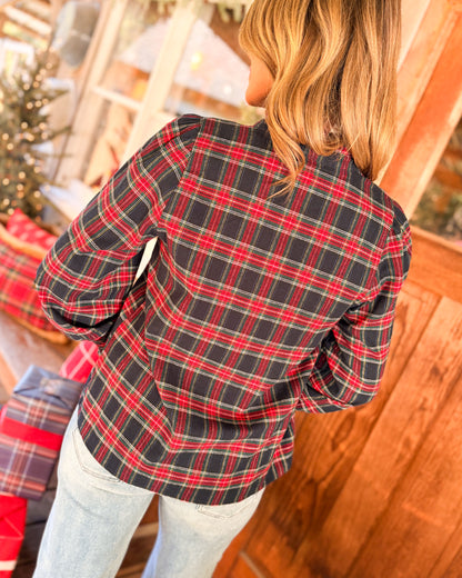 Back view of a navy and red plaid long sleeve shirt