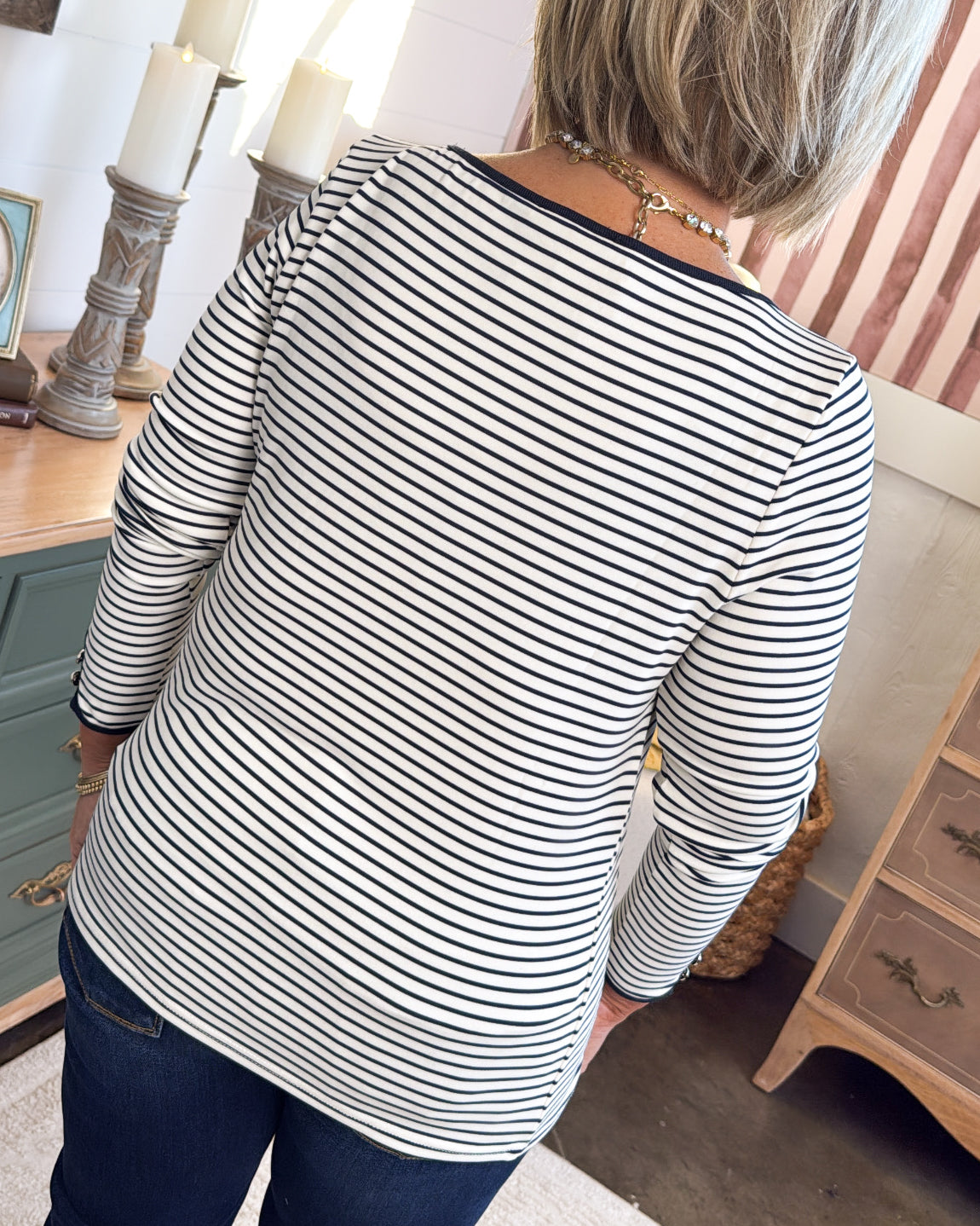 Back view of the ivory and black striped top with a black neckline trim