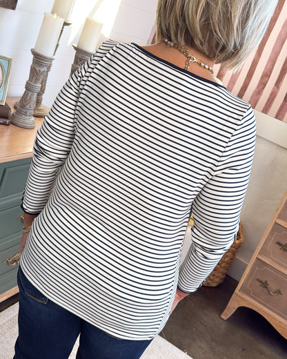 Back view of the ivory and black striped top with a black neckline trim